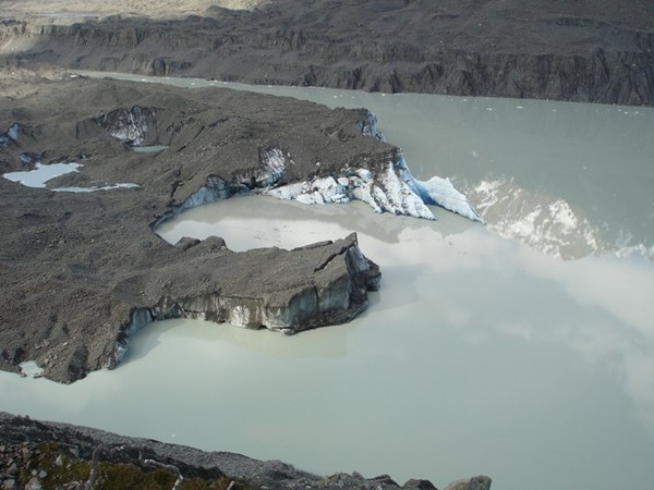 The glacier terminal face with uplifted white ice before calving